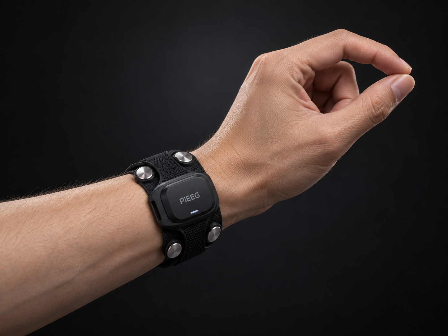 Aura VR wristband on a wrist, four EMG contacts around a sensor puck